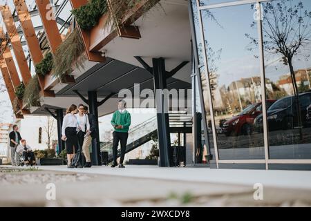 Entrepreneurial team collaborating during informal outdoor business meeting Stock Photo