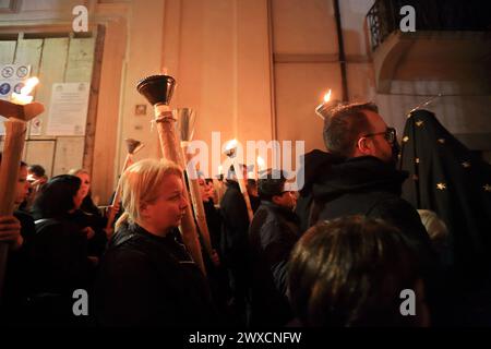 Sessa Aurunca, Italy. 29th Mar, 2024. March 29, 2024, Caserta, Italy :Women hold large lit candles while take part during the Holy Friday procession from Church of San Giovanni to Villa. on March 29, 2024, Caserta, Italy. (Photo by Pasquale Senatore/Eyepix Group/Sipa USA) Credit: Sipa USA/Alamy Live News Stock Photo