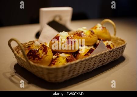 Group of delicious buns in wicker basket on the table Stock Photo