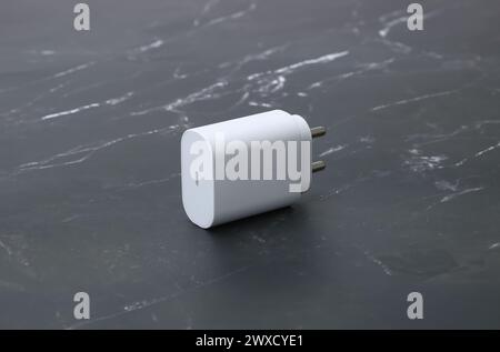 two pin smatphone white color charger isolated on black marble background Stock Photo