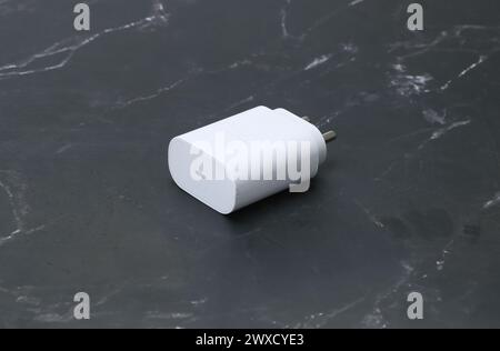 two pin smatphone white color charger isolated on black marble background Stock Photo