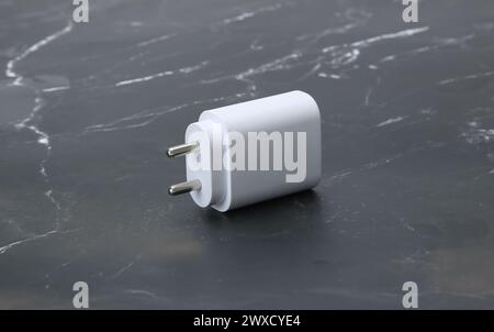 two pin smatphone white color charger isolated on black marble background Stock Photo