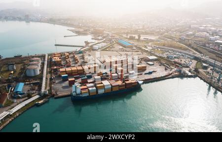 Aerial view of cargo port with containers at dawn. Reflects the hustle of global trade. Highlights the sea freight logistics system. Stock Photo