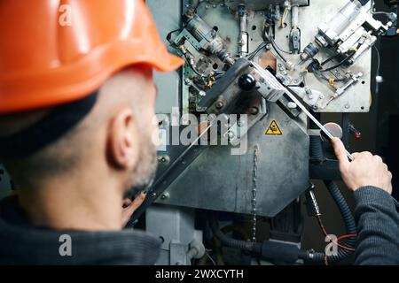 Worker cuts spacer frames in a window production Stock Photo