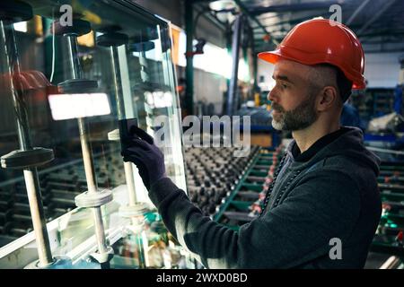 Employee uses special tools for working with glass Stock Photo