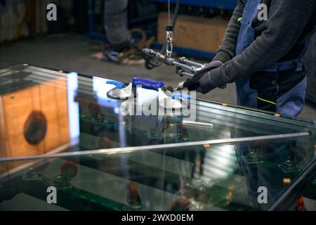 Worker uses special parts for the manufacture of double-glazed windows Stock Photo
