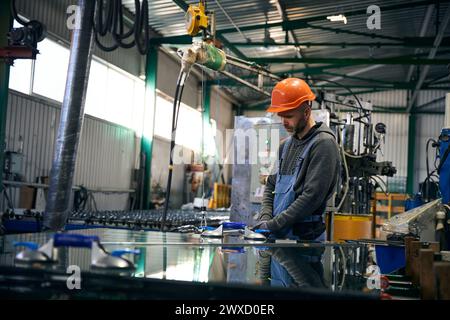 Worker uses special tools for working with glass Stock Photo