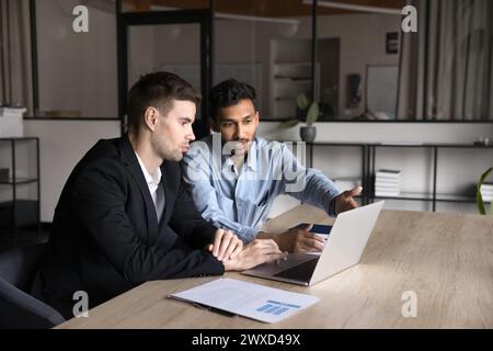 Serious multiethnic business colleagues working on job tasks together Stock Photo