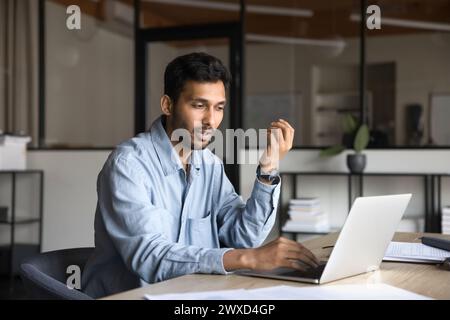 Serious Indian project manager man talking to client Stock Photo
