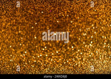 Background sequin. glitter surfactant. Holiday abstract gold, glitter background with blinking lights. Fabric sequins in bright colors. Fashion fabric Stock Photo