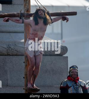 Trafalgar Square, London, UK. 29th Mar, 2024. For Good Friday 100 Wintershall players bring their moving portrayal of the final days of Jesus to Trafalgar Square in the capital in an open air production watched by thousands of spectators. Credit: Malcolm Park/Alamy Stock Photo