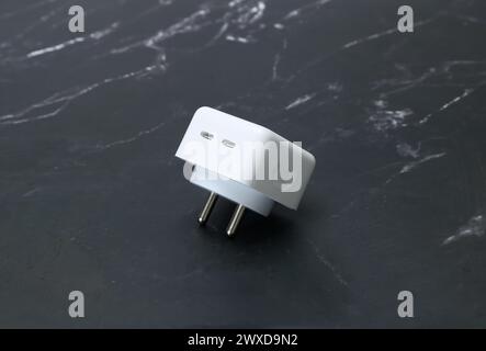 white smartphone chargers on the black marble background Stock Photo