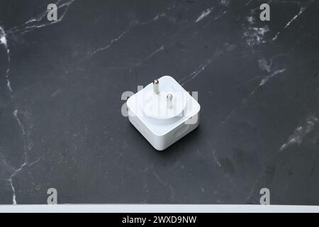 white smartphone chargers on the black marble background Stock Photo