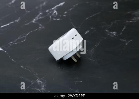 white smartphone chargers on the black marble background Stock Photo