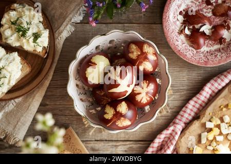 Homemade Easter eggs dyed with onion skins, with slices of sourdough bread with spread made from leftover hard-boiled eggs Stock Photo