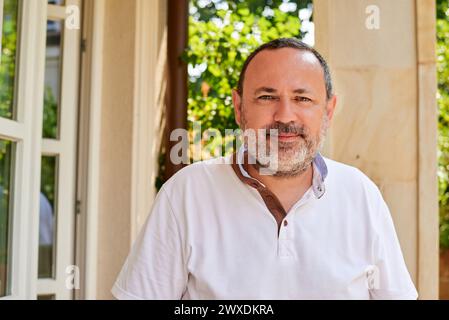 Middle-age man in a white shirt relaxing on a summer day - portrait Stock Photo