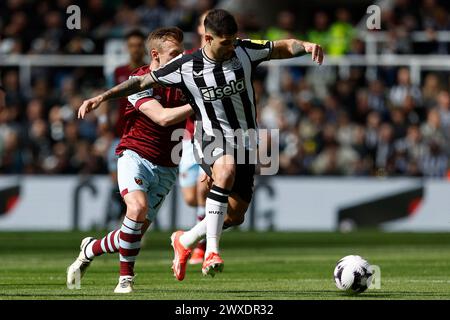 Newcastle United's Bruno Guimaraes battles with West Ham United's James Ward-Prowse during the Premier League match between Newcastle United and West Ham United at St. James's Park, Newcastle on Saturday 30th March 2024. (Photo: Mark Fletcher | MI News) Credit: MI News & Sport /Alamy Live News Stock Photo