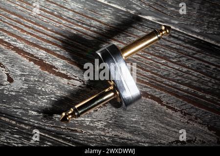guitar pedal slider plug on wood background Stock Photo
