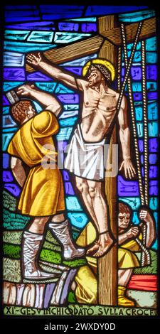 MILAN, ITALY - MARCH 48 2024: The  Jesus is nailed to the cross in the church Chiesa di San Gregorio Barbarigo from 20. cent. Stock Photo