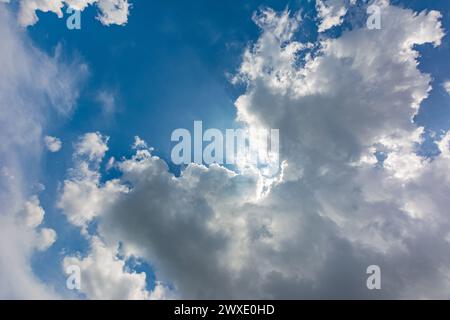 Some cumulus cloud is covering the sun. Rays through clouds. Frog eye view. Stock Photo