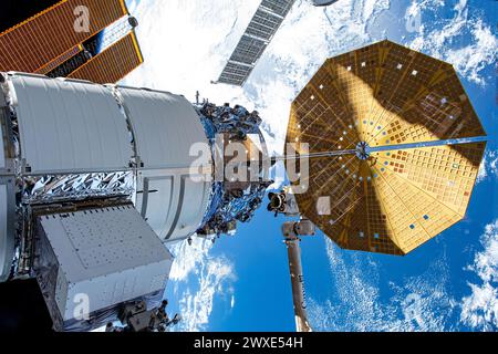 Northrop Grumman's Cygnus space freighter is pictured attached to the International Space Station while orbiting 264 miles above the Indian Ocean south of  Madagascar. At lower center, is the Canadarm2 robotic arm preparing to grapple Cygnus ahead of its removal from the Unity module and departure from the orbital outpost.   An optimised version of an original NASA image. Credit: NASA Stock Photo