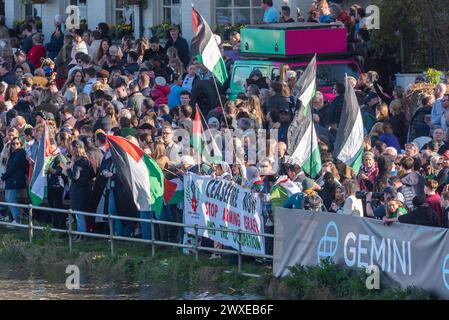 Chiswick Bridge, Chiswick, London, UK. 30th Mar, 2024. The finish line of the University Boat Race is just before Chiswick Bridge on the River Thames. Pro Palestine protesters were among the crowds at the finish Stock Photo