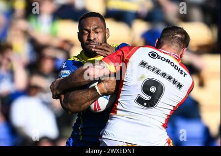 Rodrick Tai of Warrington Wolves is tackled by Micky McIlorum of Catalan Dragons during the Betfred Super League match Warrington Wolves vs Catalans Dragons at Halliwell Jones Stadium, Warrington, United Kingdom, 30th March 2024 (Photo by Craig Thomas/News Images) in, on 3/30/2024. (Photo by Craig Thomas/News Images/Sipa USA) Credit: Sipa USA/Alamy Live News Stock Photo