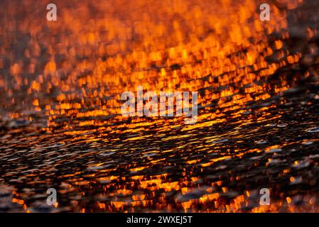 Gilded Ripples Dance Upon Molten Waters Stock Photo