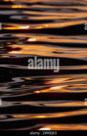 Gilded Ripples Dance Upon Molten Waters Stock Photo