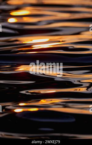 Gilded Ripples Dance Upon Molten Waters Stock Photo