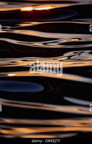 Gilded Ripples Dance Upon Molten Waters Stock Photo