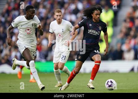 LONDON, ENGLAND - MARCH 30: Tahith Chong of Luton Town under pressure from Pape Matar Sarr of Tottenham Hotspur during the Premier League match between Tottenham Hotspur and Luton Town at Tottenham Hotspur Stadium on March 30, 2024 in London, England.(Photo by Dylan Hepworth/MB Media) Stock Photo