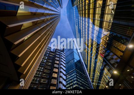 London, UK: Tall buildings in the City of London at night with (L-R): the Willis Building, the Lloyds Building, the Cheesegrater and the Scalpel. Stock Photo