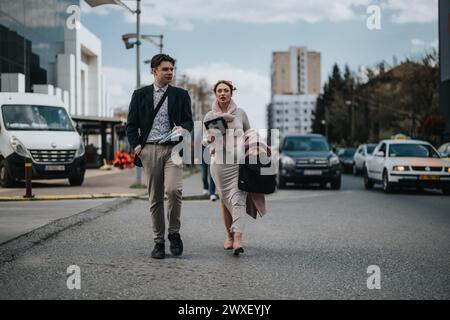 Young business partners walking in urban city discussing growth strategies Stock Photo