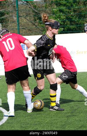 Royal National College for the Blind, Hereford, UK – Saturday 30th March 2024 – Round 3 of the European Blind Football League ( EBFL ) held at the Royal National College for the Blind at Hereford featuring six European teams. A player from Borussia Dortmund BVB is tackled by players from Pirsos Thessaloniki of Greece. Photo Steven May / Alamy Live News Stock Photo