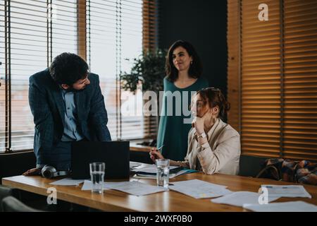 Team of business professionals reviewing documents in a modern office setting Stock Photo