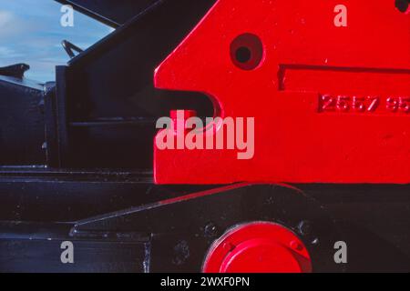 Close-up of a red industrial machinery part with focus on the interlocking components Stock Photo