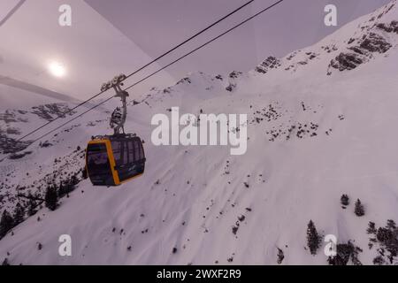 OBERSTDORF, GERMANY - FEBRUARY 24, 2024: Cabin of the Nebelhorn cable car in the Alps. View from parallel cabin Stock Photo