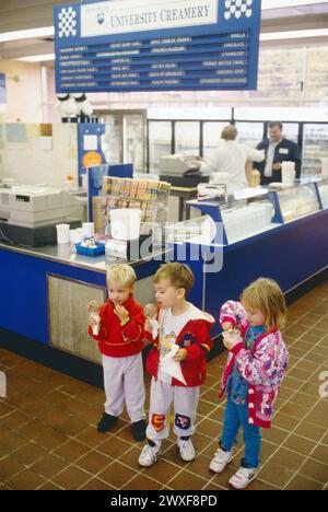 Three small chilldren enjoy fresh ice cream cones at The Creamery, State College, Pennsylvania, USA Stock Photo