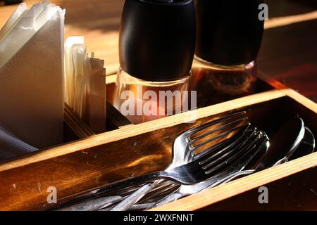 Cutlery - forks and spoons on a table in a cafe Stock Photo