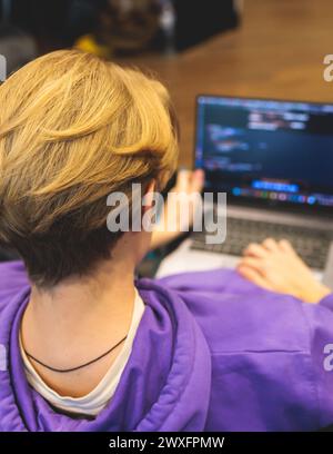 Software developer students in auditorium hall working on computer and laptop, programming contest hackathon competition, pc with coding program app, Stock Photo