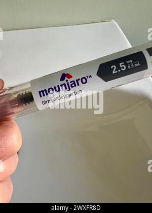 Hand holding a Mounjaro injectable pen Stock Photo