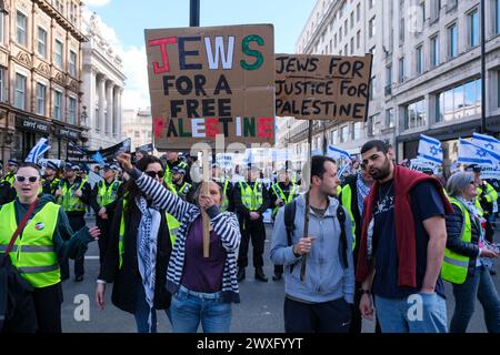 London, UK, 30th March, 2024. Two pro-Palestine Jewish protesters stand in front of the Israeli counter-demonstration held along the route of the eleventh national Palestinian march. The group carried the national flag and kidnapped posters, as they called for the release of hostages still held in Gaza. Credit: Eleventh Hour Photography/Alamy Live News Stock Photo