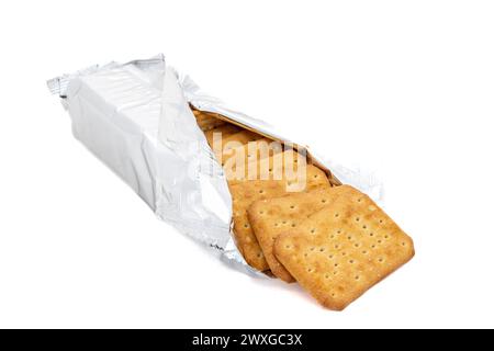 Salty crunchy cracker cookies in a wrapping paper on white isolated background Stock Photo