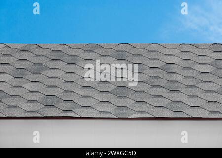 Grey mosaic tile roof house structure abstract building home pattern design object blue sky background. Stock Photo