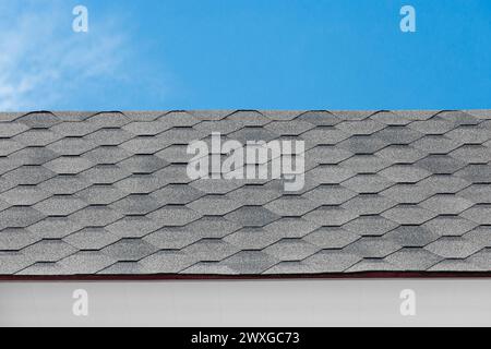Grey mosaic tile roof house abstract building home pattern design object on blue sky background. Stock Photo