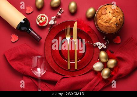 Beautiful table setting with Easter eggs on red background Stock Photo