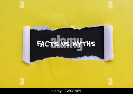 Facts vs myths words written on yellow torn paper with black background. Conceptual symbol. Copy space. Stock Photo