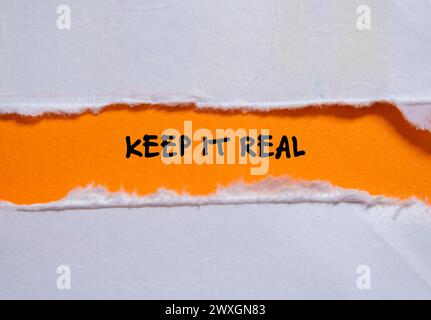 Keep it real words written on torn paper with orange background. Conceptual symbol. Copy space. Stock Photo