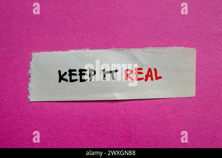 Keep it real words written on torn paper piece with pink background. Conceptual symbol. Copy space. Stock Photo